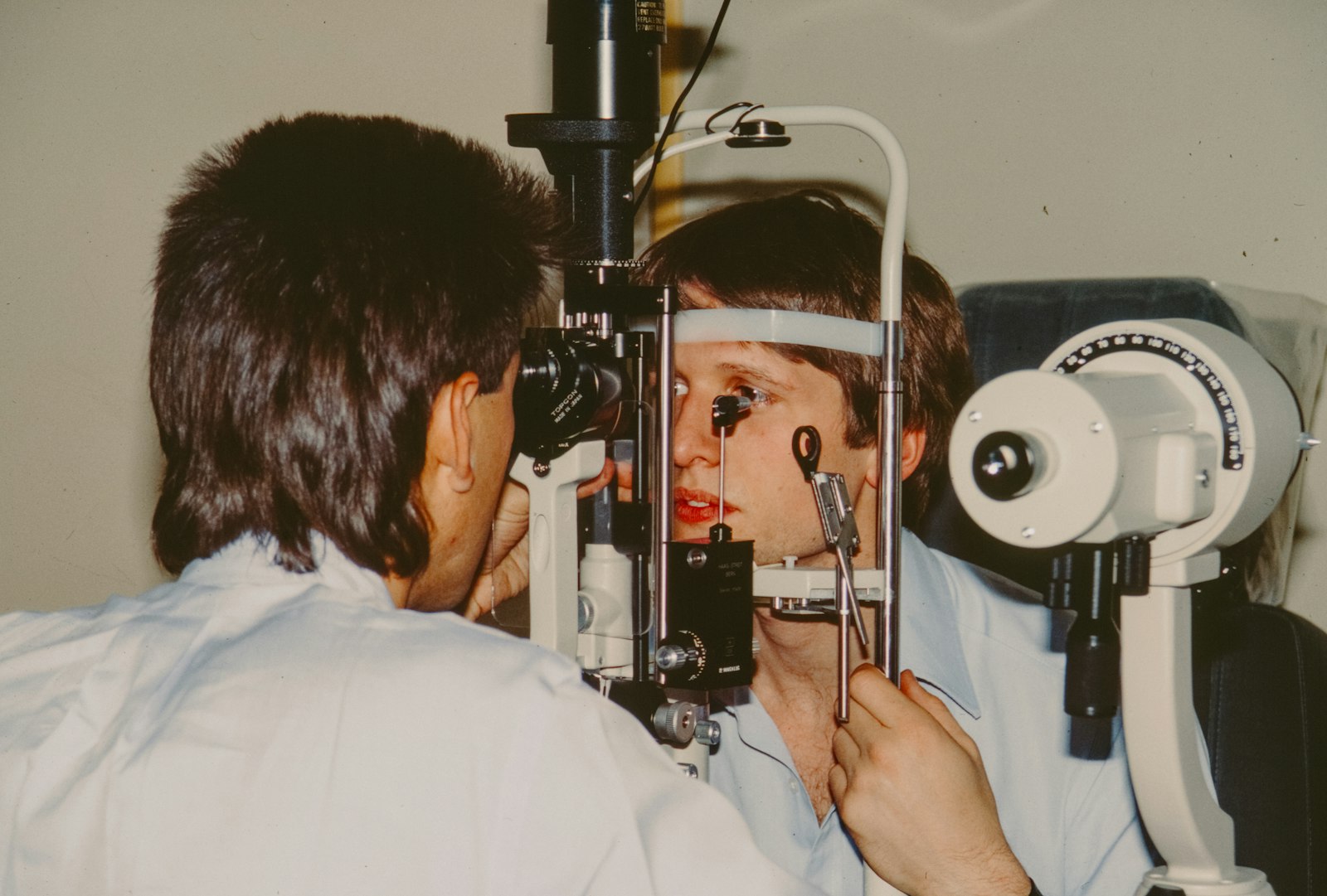 Optometrist examining a patient's eye